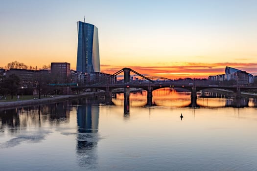Frankfurt, Germany - February 28, 2023: scenic view to skyline of Frankfurt am Main with reflection of the european central bank in river Main.