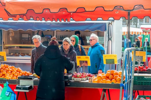 Wiesbaden, Germany - February 25, 2023: farmers sell fresh vegetables and fruits at the farmers market in Wiesbaden to local people.