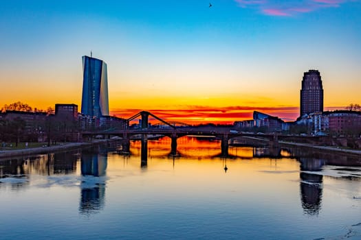Frankfurt, Germany - February 28, 2023: scenic view to skyline of Frankfurt am Main with reflection of the european central bank in river Main.