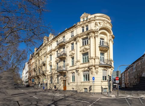 Wiesbaden, Germany - March 2, 2023: people at Kaiser Friedrich Ring - engl: King Friedrich circle - with its old scenic facade of the 19th century in classicistic and Art Nouveau style.