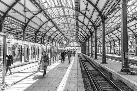 Wiesbaden, Germany - April 4, 2023:  people wait in the train station for departure in classicistic train station in Wiesbaden, the smaller copy of Frankfurt Train station.