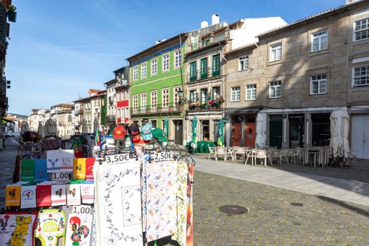 Braga, Portugal - May 1, 2023:street scene in the old town of Braga with historic facades and people in early morning.