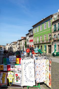 Braga, Portugal - May 1, 2023:street scene in the old town of Braga with historic facades and people in early morning.