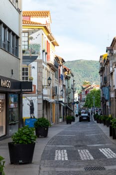 Chaves, Portugal - May 1, 2023: scenic narrow street in Chaves in early morning light with cobble stones and old historic houses.