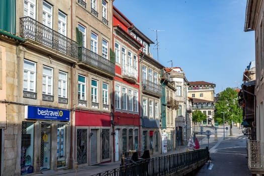 Chaves, Portugal - May 1, 2023: scenic narrow street in Chaves in early morning light with cobble stones and old historic houses.