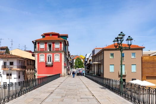 Chaves, Portugal - May 1, 2023: scenic narrow street in Chaves in early morning light with cobble stones and old historic houses.