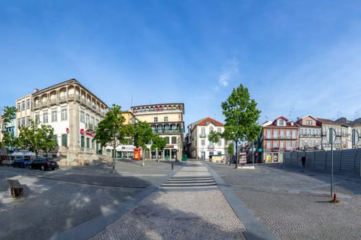 Chaves, Portugal - May 1, 2023: scenic narrow street in Chaves in early morning light with cobble stones and old historic houses.