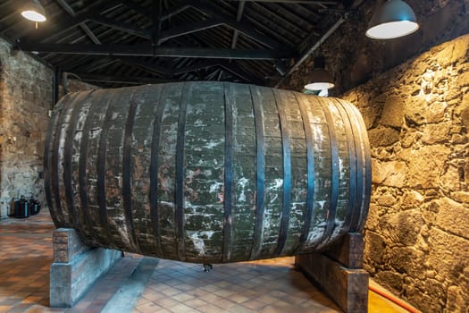 Porto, Portugal - May 3, 2023: old port wine barrel in the Burmester vinery in Gaia, Porto, Portugal.