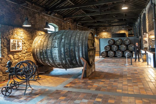 Porto, Portugal - May 3, 2023: old port wine barrel in the Burmester vinery in Gaia, Porto, Portugal.