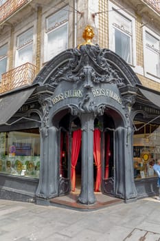 Porto, Portugal - May 3, 2023: view of the liberty decorated entrance of Reis Filhos, an historic shop in Porto