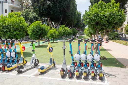 Tel Aviv, Israel - May 18, 2023: electric scooter parking space. Electric scooters are for renting by using the smartphone and the renting app. They are often used by the younger people.