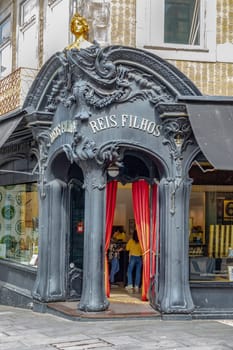 Porto, Portugal - May 3, 2023: view of the liberty decorated entrance of Reis Filhos, an historic shop in Porto