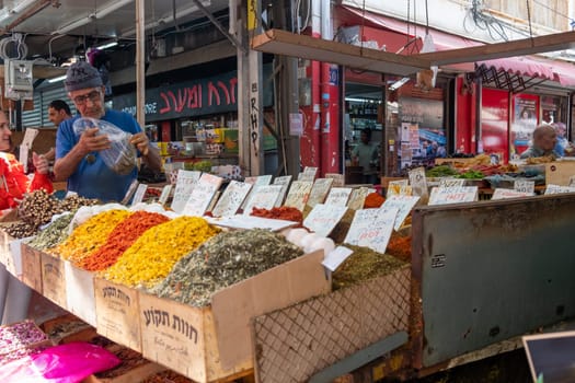 Tel Aviv, Israel - May 18, 2023 :Israeli people shopping at Carmel Market (Shuk HaCarmel) in Tel Aviv, Israel.It's a very popular marketplace in Tel Aviv sells mostly food and home accessories goods.