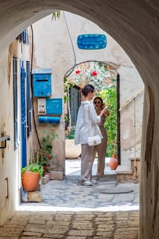 Tel Aviv, Israel - May 18, 2023: tourists enjoy walking at th old town of Tel Aviv with pittoresque old small arches, houses and courtyards.