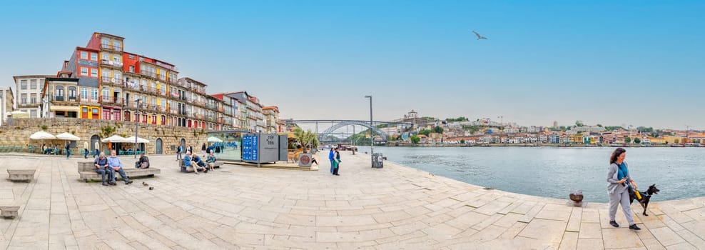 Porto, Portugal - May 4, 2023: panoramic view to promenade of Porto, Bridge and promenade of Gaia.