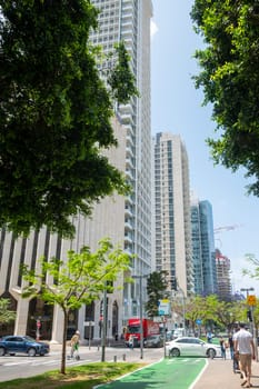 Tel Aviv, Israel - May 18, 2023: View of modern skyscrapers in the city center of Tel Aviv, Israel, at the crossroads between Sderot Rothschild and Yavne Street with street scenes.