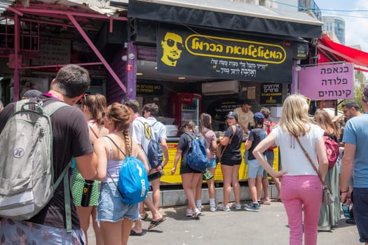 Tel Aviv, Israel - May 18, 2023 :Israeli people shopping at Carmel Market (Shuk HaCarmel) in Tel Aviv, Israel.It's a very popular marketplace in Tel Aviv sells mostly food and home accessories goods.
