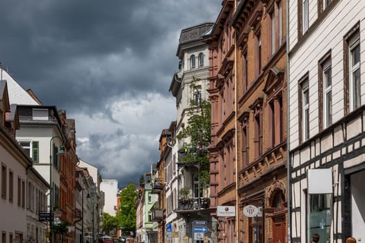 Wiesbaden, Germany - May 6, 2023: view to old historic Nerostrasse - engl: street of Neero - in bad weather situation with dark clouds.