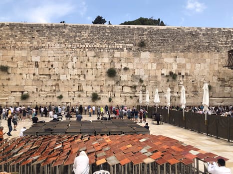 Jerusalem, Israel - May 19, 2023: Jewish worshipers are praying at the Wailing Wall in Jerusalem, Israel.