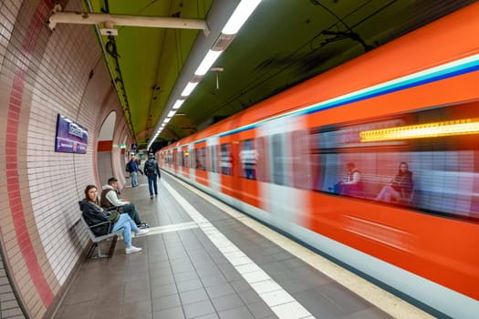 Frankfurt, Germany - May 24, 2023: people, waiting in the central station for the next metro while one metro is departing.