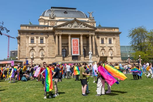 Wiesbaden, Germany - May 27, 2023: people enjoy the christopher street parade in Wiesbaden with rainbow flags and beaufiful costumes.