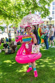 Wiesbaden, Germany - May 27, 2023: people enjoy the christopher street parade in Wiesbaden with rainbow flags and beaufiful costumes.