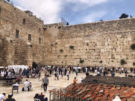 Jerusalem, Israel - May 19, 2023: Jewish worshipers are praying at the Wailing Wall in Jerusalem, Israel.