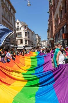 Wiesbaden, Germany - May 27, 2023: people enjoy the christopher street parade in Wiesbaden with rainbow flags and beaufiful costumes.