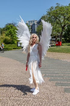Wiesbaden, Germany - May 27, 2023: people enjoy the christopher street parade in Wiesbaden with rainbow flags and beaufiful costumes.