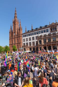 Wiesbaden, Germany - May 27, 2023: people enjoy the christopher street parade in Wiesbaden with rainbow flags and beaufiful costumes.