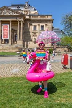 Wiesbaden, Germany - May 27, 2023: people enjoy the christopher street parade in Wiesbaden with rainbow flags and beaufiful costumes.