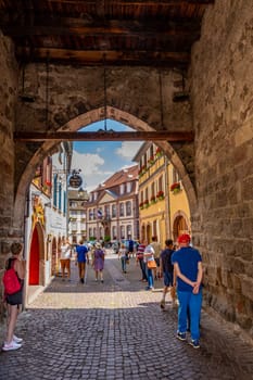 Ribeauville, France - June 23, 2023: A picturesque colorful street of half-timber buildings with shops and cafes in the village of Ribeauville, in the Alsace region.