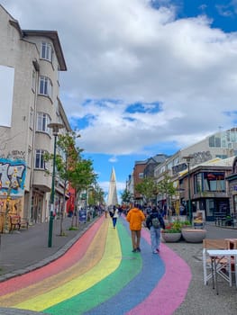 Reykjavík, Iceland - July 13, 2023: The Gay Pride rainbow from Skólavörðustígur street, one of the busiest streets leading to Hallgrimfrikja church. Once painted for Reykjavik Pride week, now permanent