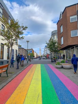 Reykjavík, Iceland - July 13, 2023: The Gay Pride rainbow from Skólavörðustígur street, one of the busiest streets leading to Hallgrimfrikja church. Once painted for Reykjavik Pride week, now permanent
