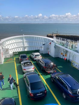 Sylt, Germany - August 21, 2023: backside view of ferry at the north sea with cars and people on deck