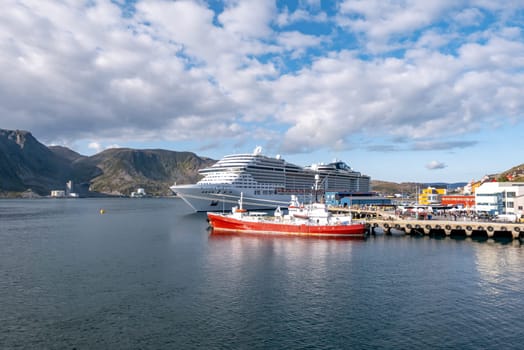 Honni9ngsvag, Norway - August 24, 2023: Troms og Finnmark, Honningsvag, view from the sea, Norway with cruise ship MSC Preziosa at the pier.