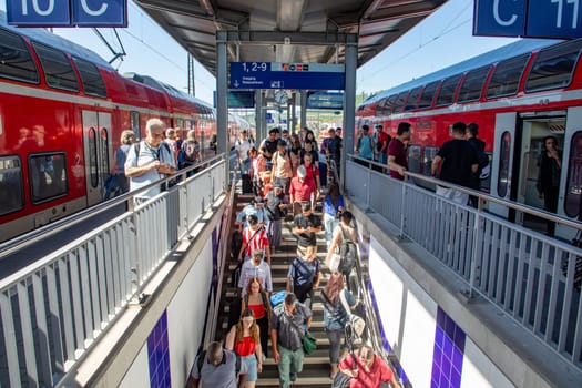 Würzburg, Germany - September 11, 2013: people at Würzburg train station wait for the train. Most of them hold a 49 Euros reduced germany ticket.