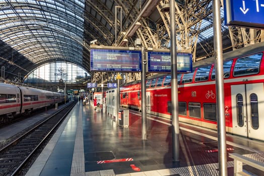 Frankfurt, Germany - September 11, 2013: people at Frankfurt train station arrive with a local red train. Most of them hold a 49 Euros reduced germany ticket.