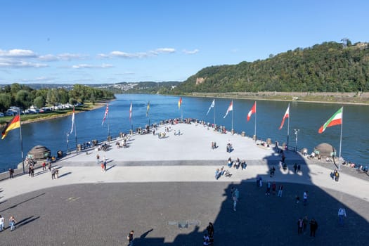 Koblenz, Germany - September 24, 2023: people promenade at river Rhine  in Koblenz at Deutsches Eck or German Corner in Koblenz, where the Mosel river joins the Rhine.