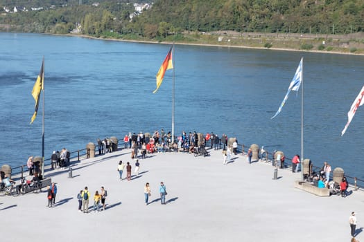 Koblenz, Germany - September 24, 2023: people promenade at river Rhine  in Koblenz at Deutsches Eck or German Corner in Koblenz, where the Mosel river joins the Rhine.