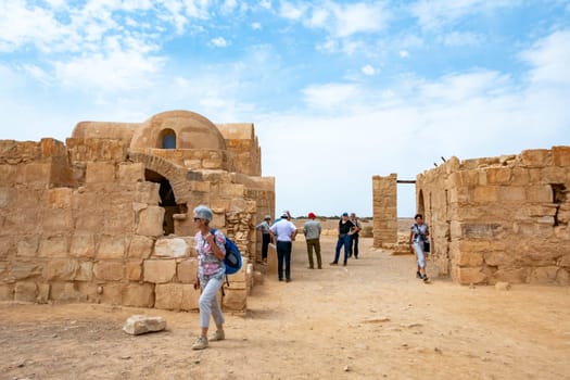 Amra, Jordan - October 5, 2023: people visit castle of Qusayr Amra in the desert in Jordan.