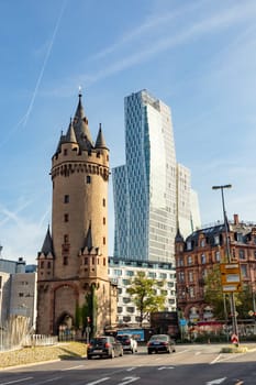 Frankfurt, Germany - October 10, 2023: view to old city gate and tower Eschesheimer Turm and modern hotel Jumeirah in Frankfurt, Germany.