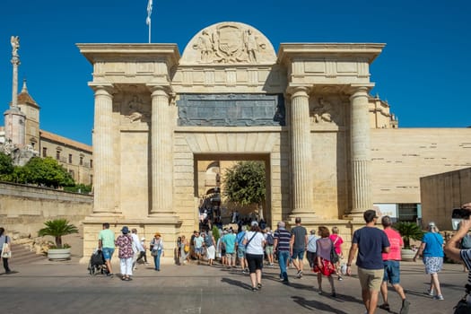 Cordoba, Spain - September 30, 2023: Puerta del Puente, City gate, Town Gate beside Roman bridge, Plaza del Triunfo, Andalusia, Spain.