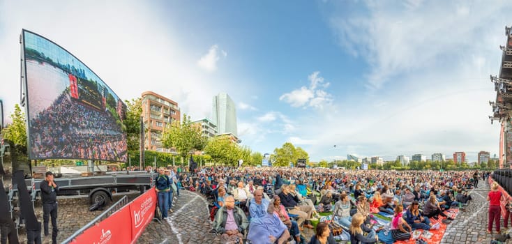 Frankfurt, Germany - August 31, 2023: people enjoy the open air festival with the HR synphony orchestra and big band at the Weseler werft in Frankfurt.