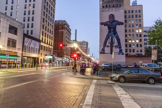 Houston, USA - October 20, 2023: nightview of downtown street in Houston. BMX bike advertising at a house wall and downtown street scene.