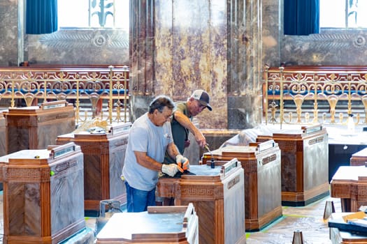 Baton Rouge, USA - October 23, 2023: inside the state capitol building in Baton Rouge, USA. Worker are cleaning the old wooden tables of the members of Senate.
