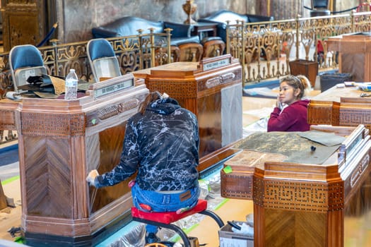 Baton Rouge, USA - October 23, 2023: inside the state capitol building in Baton Rouge, USA. Worker are cleaning the old wooden tables of the members of Senate.