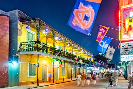New Orleans, USA - October 24, 2023: people enjoy Pubs and bars with neon lights in the French Quarter, downtown New Orleans.