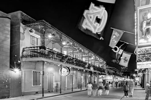 New Orleans, USA - October 24, 2023: people enjoy Pubs and bars with neon lights in the French Quarter, downtown New Orleans.