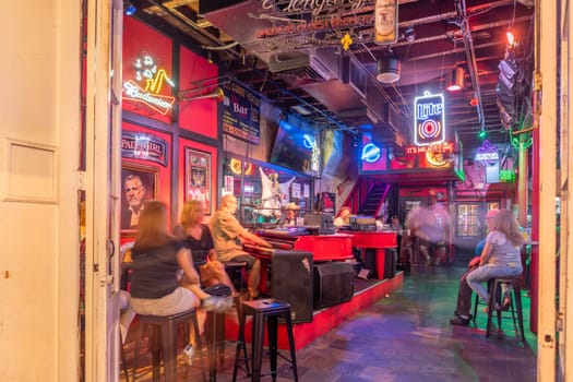New Orleans, USA - October 24, 2023: Pubs and bars with neon lights in the French Quarter, downtown New Orleans.